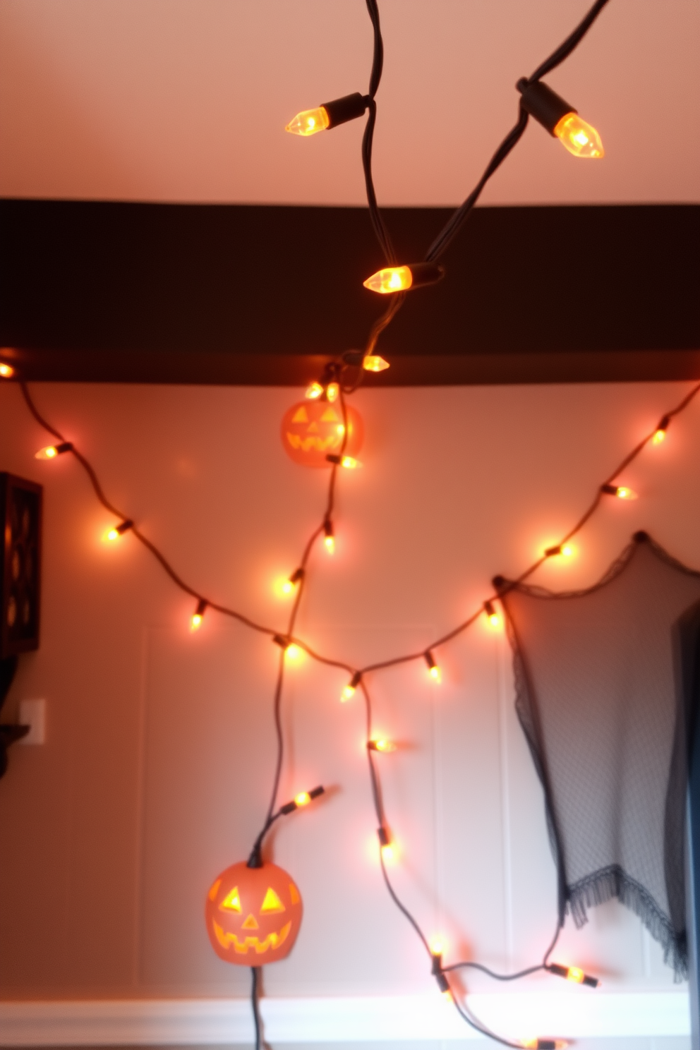 String lights with orange bulbs create a warm and inviting atmosphere for a cozy Halloween-themed small space. The lights are draped elegantly across the walls and ceiling, casting a soft glow that enhances the festive decor.