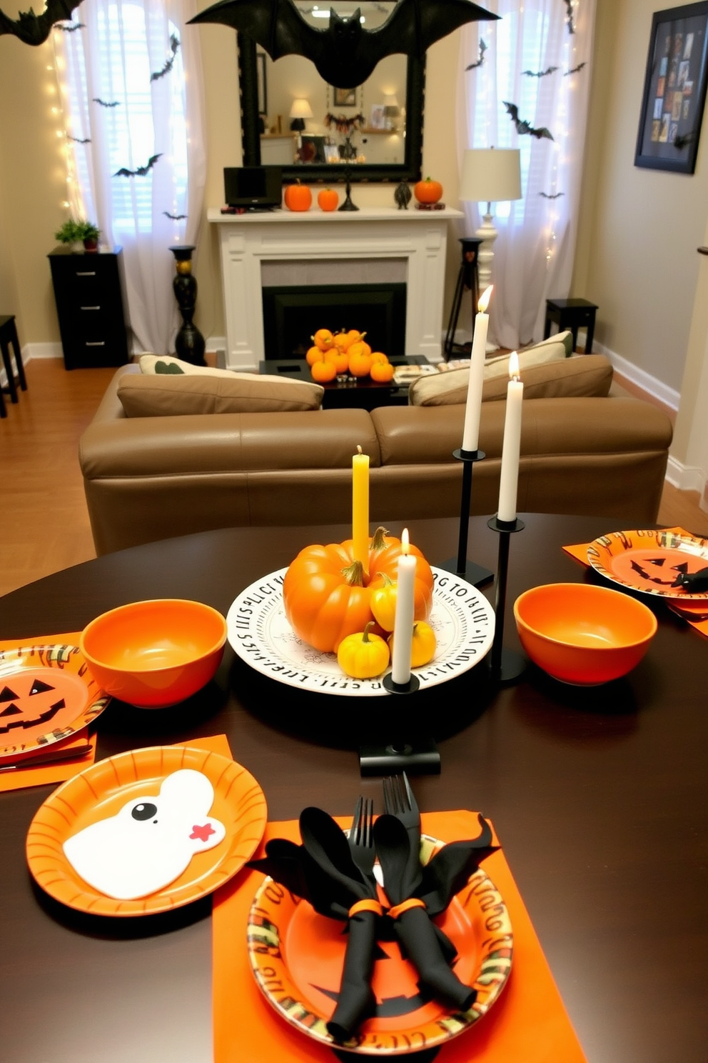 Festive dishware for Halloween snacks. The table is adorned with a variety of themed plates and bowls featuring pumpkin and ghost designs, complemented by vibrant orange and black napkins. Halloween Small Space Decorating Ideas. The living area is decorated with string lights shaped like bats, while a small table displays a centerpiece of mini pumpkins and a spooky candle arrangement.