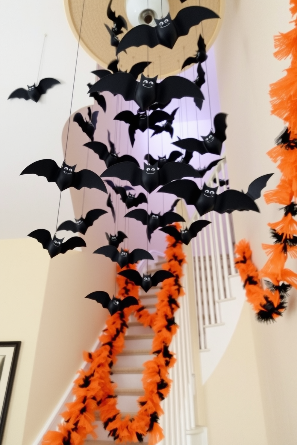 A whimsical Halloween staircase adorned with hanging bats from the ceiling. The staircase is decorated with orange and black garlands, creating a festive atmosphere as the bats dangle playfully above.