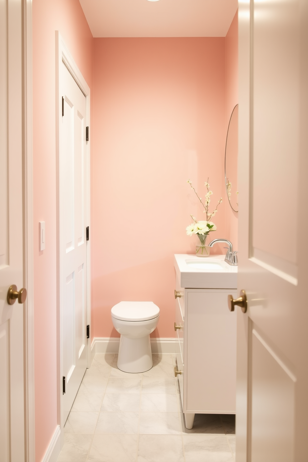 A serene hallway bathroom featuring soft pastel hues that create a calming effect. The walls are painted in a gentle blush pink, complemented by a light mint green accent on the cabinetry. The flooring consists of pale gray tiles that enhance the tranquil atmosphere. A sleek white vanity with a round mirror above it reflects the soft lighting, while delicate floral arrangements add a touch of elegance.