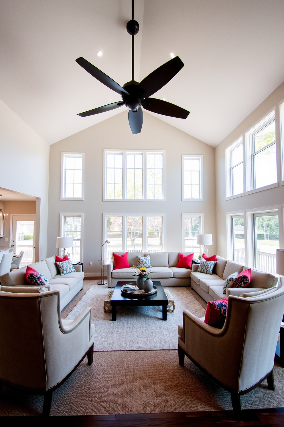 A high ceiling living room with a dramatic ceiling fan as the focal point. The space features a large sectional sofa in a neutral tone, complemented by vibrant throw pillows that add color and texture. Large windows allow natural light to flood the room, creating a bright and airy atmosphere. A stylish coffee table sits in the center, surrounded by elegant accent chairs that enhance the overall design.