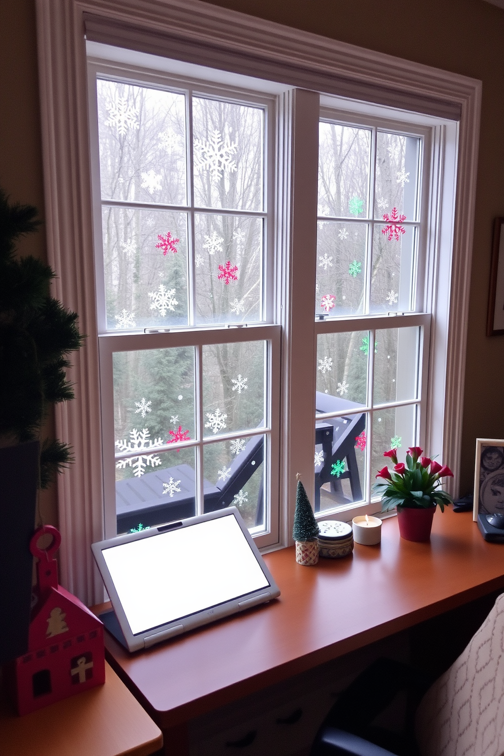 Create a cozy home office decorated for Christmas. The windows are adorned with colorful festive window clings featuring snowflakes and holiday motifs, bringing a cheerful atmosphere to the workspace.