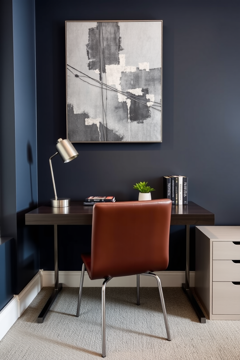 A sleek home office designed for a modern man. The space features a dark wood desk with metal legs, paired with a comfortable leather chair that has a minimalist design. The walls are painted in a deep navy blue, creating a sophisticated backdrop. A large abstract artwork with metallic elements hangs above the desk, adding a focal point to the room. On the desk, a stylish desk lamp with a brushed steel finish provides ample lighting. A few neatly organized books and a small potted plant add personality without cluttering the space.