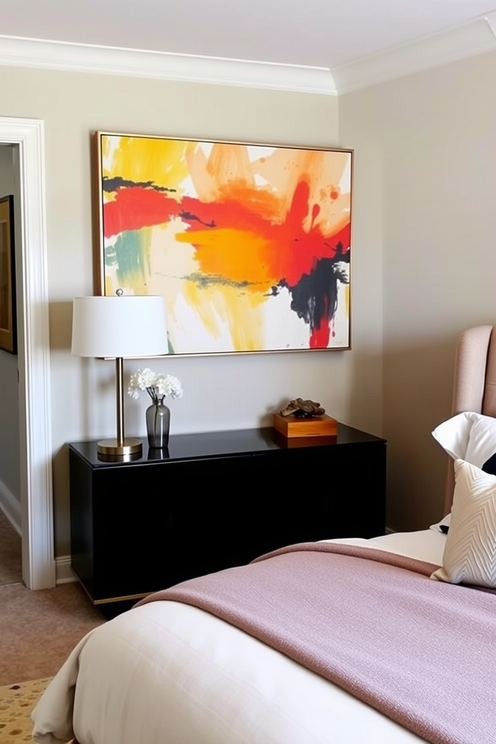 Artistic wall art to personalize space. A large abstract painting in vibrant colors hangs above a sleek console table, creating a focal point in the room. In-Law Bedroom Design Ideas. The bedroom features a cozy queen-sized bed with soft linens and a plush headboard, complemented by a bedside table with a stylish lamp.