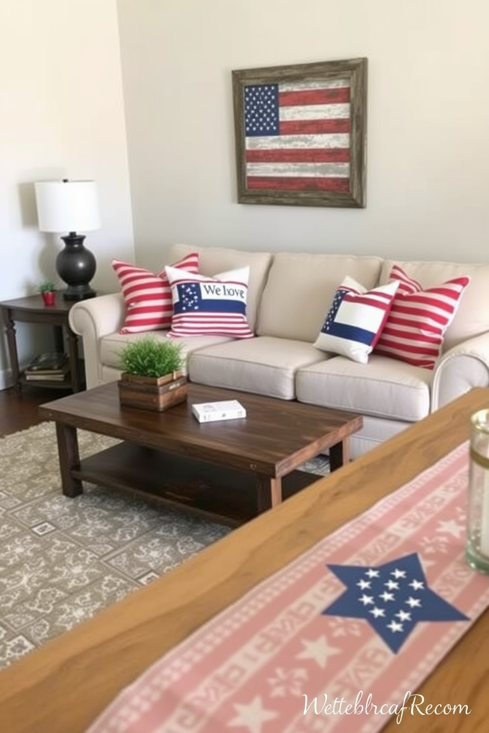 Create a cozy living room setting featuring a neutral sofa adorned with red white and blue throw pillows celebrating Independence Day. The space includes a rustic coffee table, a patriotic-themed wall art piece, and a festive table runner that adds a touch of holiday spirit.