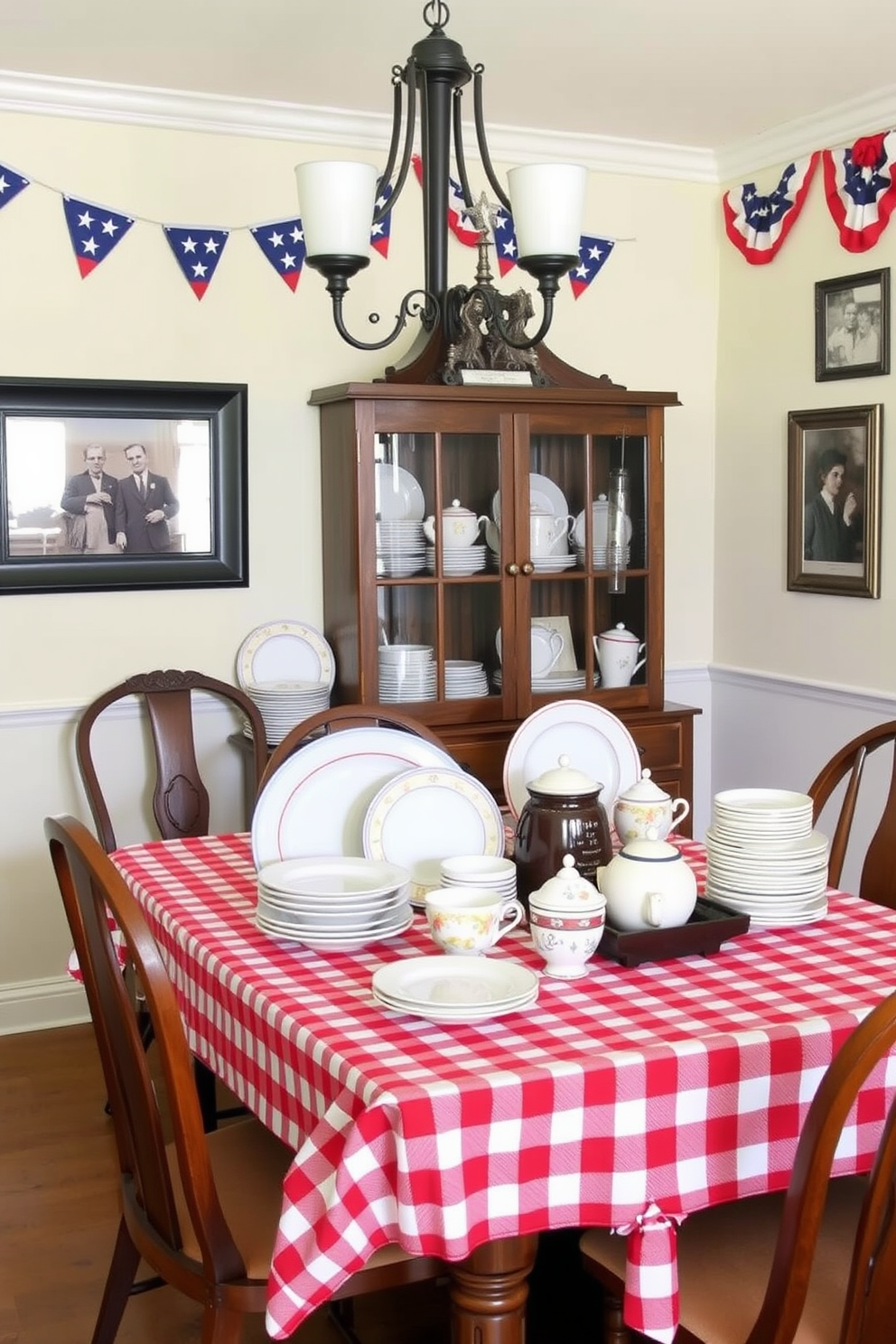 A charming dining room setting showcasing a vintage Americana dishware display. The table is adorned with a red and white checkered tablecloth, and the walls are decorated with patriotic bunting and framed vintage photographs.