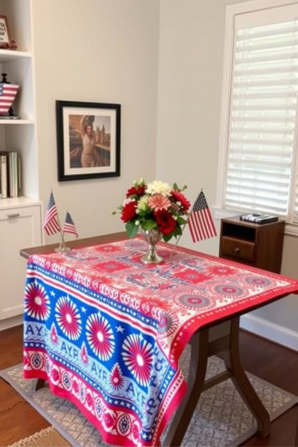 A festive tablecloth drapes over a sleek wooden desk in a home office, adorned with vibrant red, white, and blue patterns celebrating Independence Day. Surrounding the workspace are decorative elements like miniature American flags and a centerpiece featuring fresh flowers in patriotic colors.