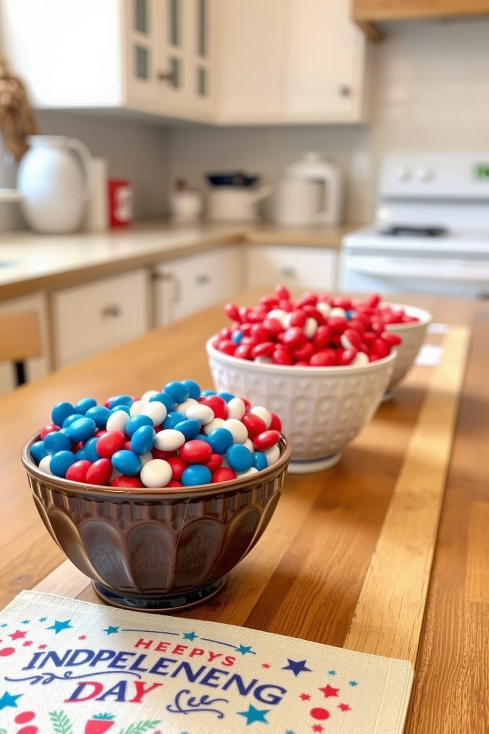 A festive kitchen setting showcasing decorative bowls filled with vibrant red white and blue candies. The bowls are placed on a rustic wooden countertop adorned with a cheerful Independence Day table runner.