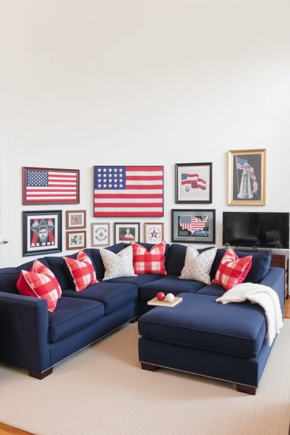 A patriotic themed wall art gallery is showcased in a spacious living room. The gallery features a collection of framed artwork depicting the American flag and iconic national symbols. The walls are painted in a soft white to enhance the vibrant colors of the art. A comfortable sectional sofa in navy blue is positioned to create a cozy gathering space, complemented by red and white throw pillows.