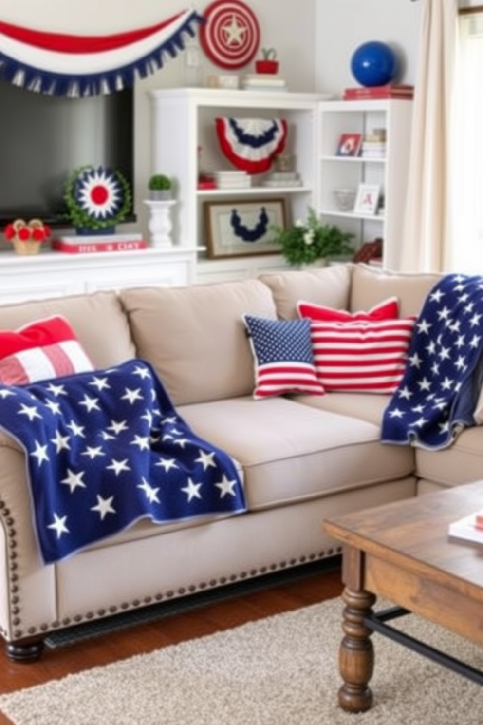 A cozy living room adorned with American flag throw blankets draped over a plush sectional sofa. The space features festive decorations celebrating Independence Day, including red, white, and blue accents throughout the room.