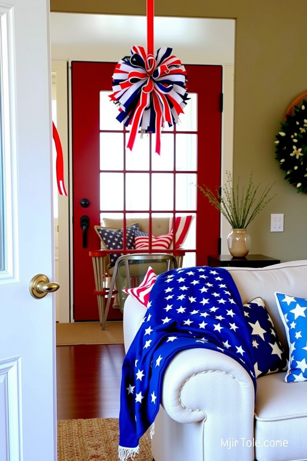 A festive wreath adorned with red white and blue ribbons hangs on the front door welcoming guests. Inside the living room patriotic accents abound with a cozy arrangement of star patterned cushions on a neutral sofa and a vibrant American flag draped over the armrest.