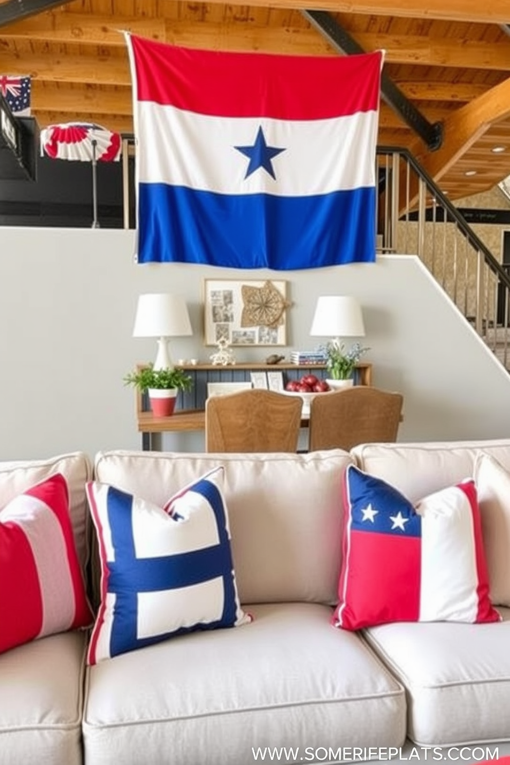 Create a cozy loft living space decorated for Independence Day. The sofa is adorned with patriotic throw pillows in red white and blue featuring stars and stripes patterns.