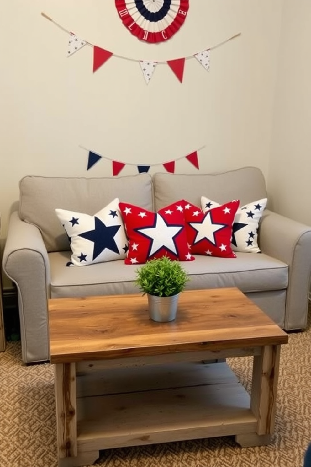 Create a cozy living room scene featuring accent pillows adorned with star patterns in red, white, and blue to celebrate Independence Day. The pillows are arranged on a light gray sofa, which is complemented by a small coffee table made of reclaimed wood. In the background, a patriotic banner hangs on the wall, and a small potted plant sits on the table to add a touch of greenery. The overall atmosphere is festive yet inviting, perfect for a small space celebrating the holiday.