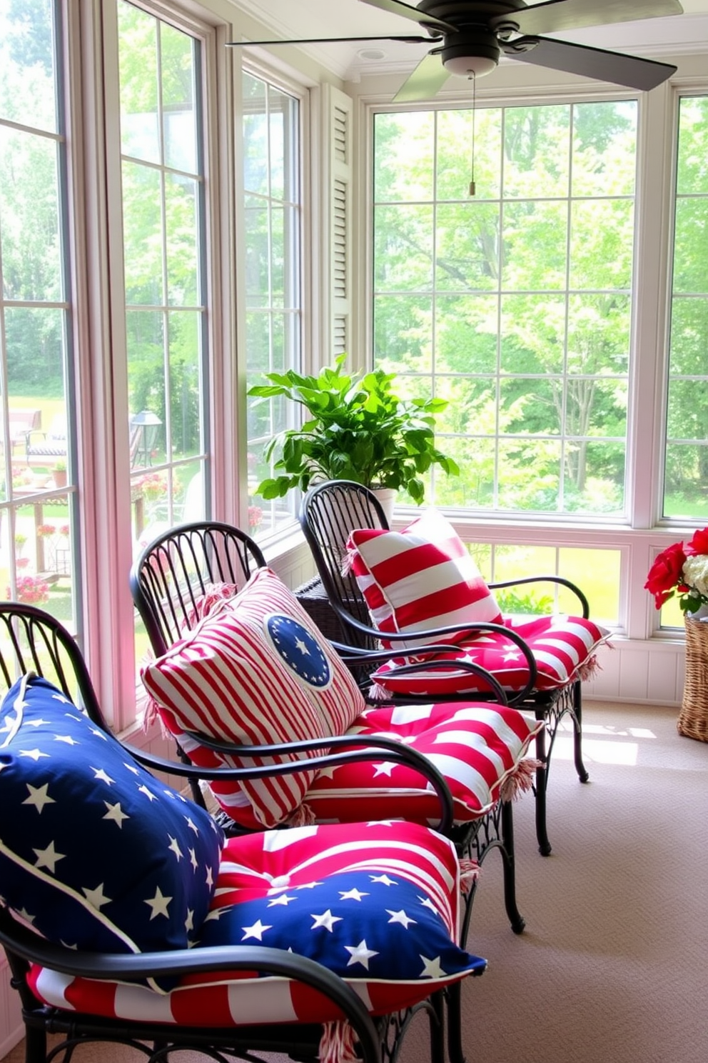 Patriotic colored cushions adorn the chairs in a bright sunroom, creating a festive atmosphere for Independence Day celebrations. The sunroom features large windows that allow natural light to flood in, highlighting the vibrant red, white, and blue patterns of the cushions.