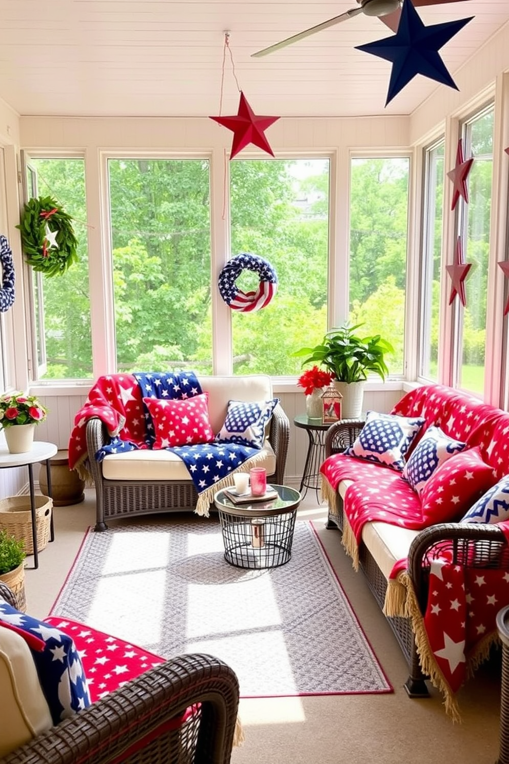 A sunroom decorated for Independence Day features red white and blue patterned blankets draped over comfortable seating. The space is filled with natural light, and patriotic decorations like stars and stripes add a festive touch.