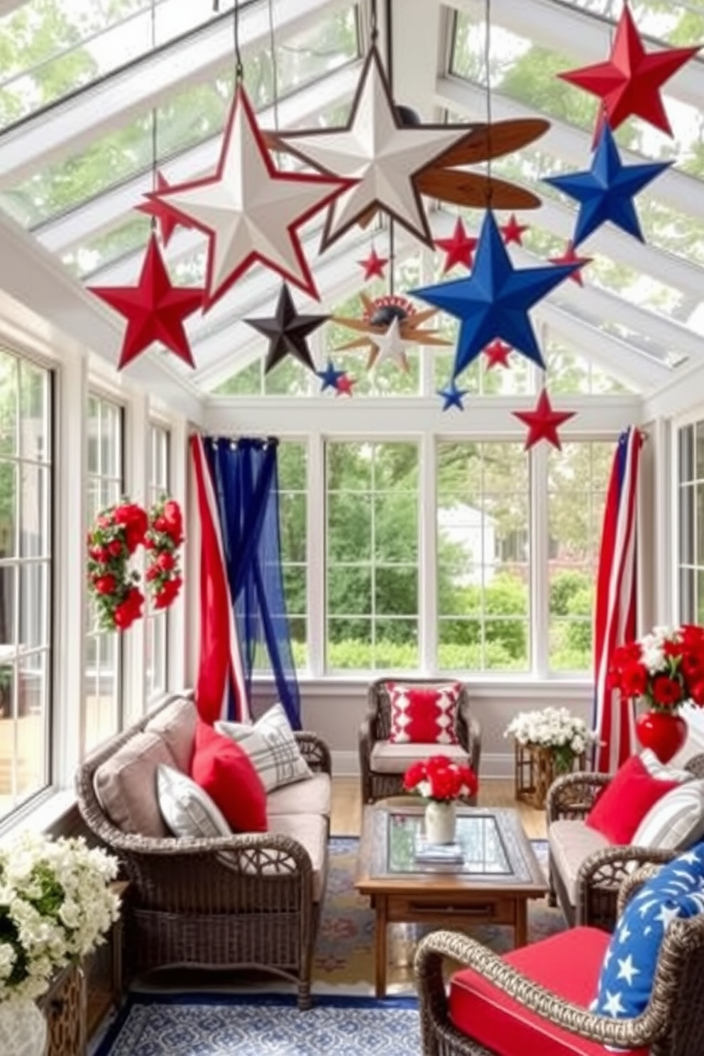 Create a sunroom decorated for Independence Day featuring tables adorned with patriotic themed candles in red white and blue. The candles vary in height and design creating a festive atmosphere complemented by vibrant floral arrangements in matching colors.