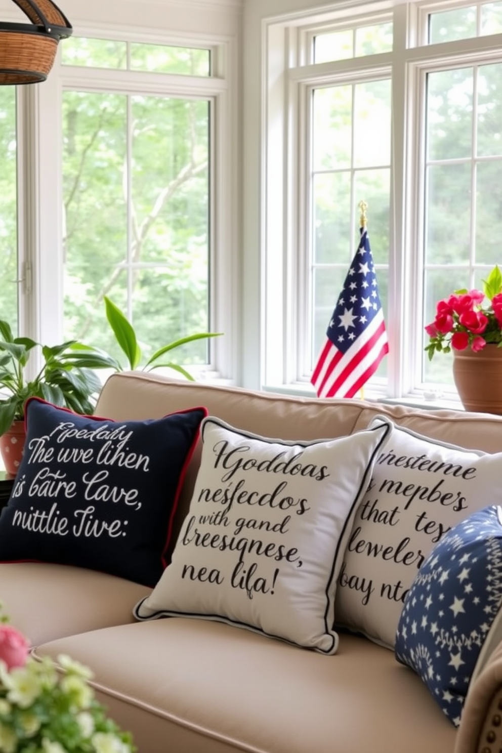 Decorative pillows adorned with inspiring quotes about freedom are placed on a cozy sunroom sofa. The sunroom is filled with natural light, featuring large windows and lush greenery that enhance the festive atmosphere of Independence Day.