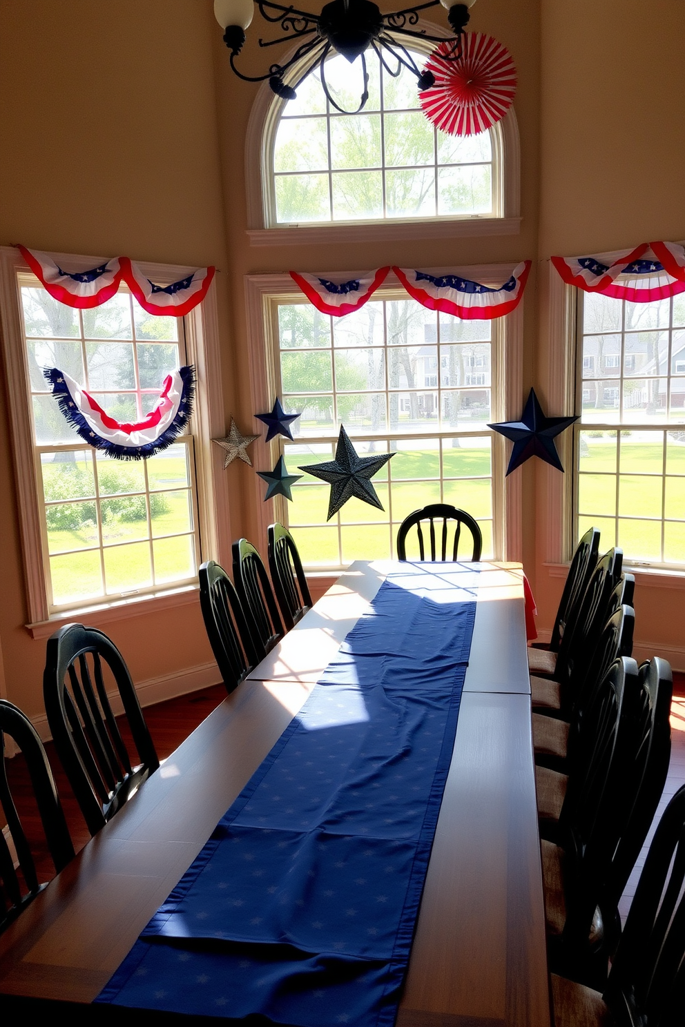 A festive dining room setting showcasing themed tablecloths draped elegantly over a long wooden table. The tablecloths feature vibrant red, white, and blue patterns, visible through large windows adorned with patriotic bunting. Sunlight filters through the windows, casting a warm glow on the table setting. In the background, decorative stars and stripes accents enhance the Independence Day theme, creating a celebratory atmosphere.