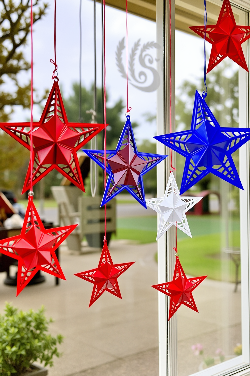 Create a festive window display for Independence Day featuring hanging stars in red white and blue. The stars are intricately designed and suspended from the window frames to create a patriotic atmosphere.