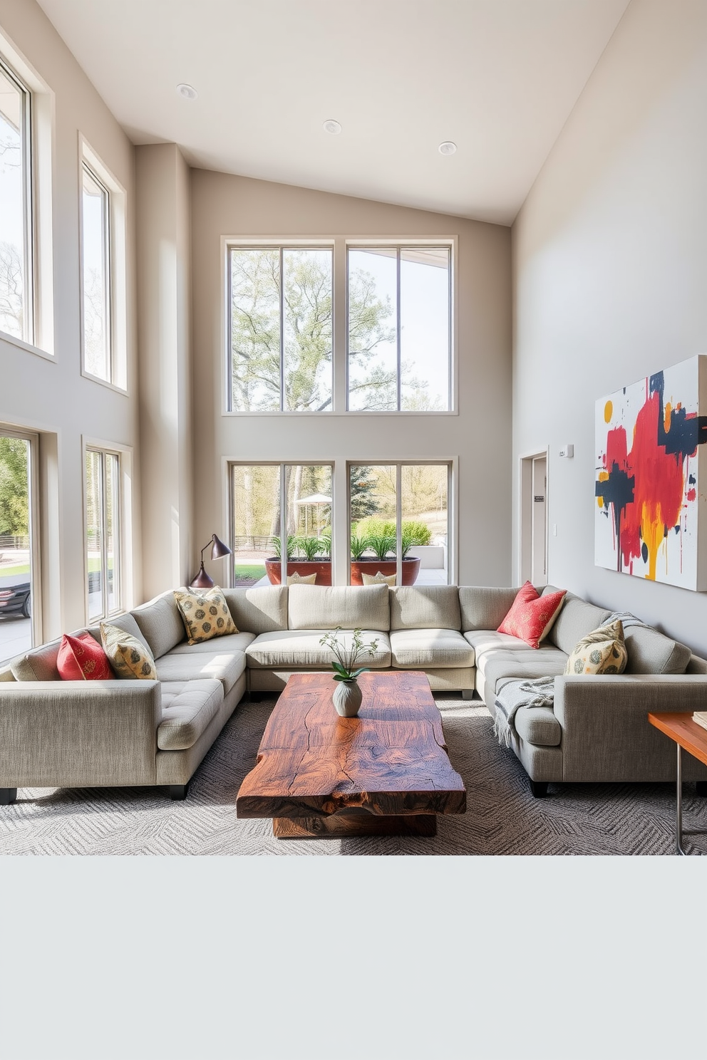 Open layout for spacious feel and flow. The living room features large windows that allow natural light to flood the space, with a neutral color palette that enhances the airy atmosphere. A plush sectional sofa is positioned to encourage conversation, complemented by a stylish coffee table made of reclaimed wood. Decorative accents include vibrant throw pillows and a large piece of abstract art that adds a pop of color to the walls.