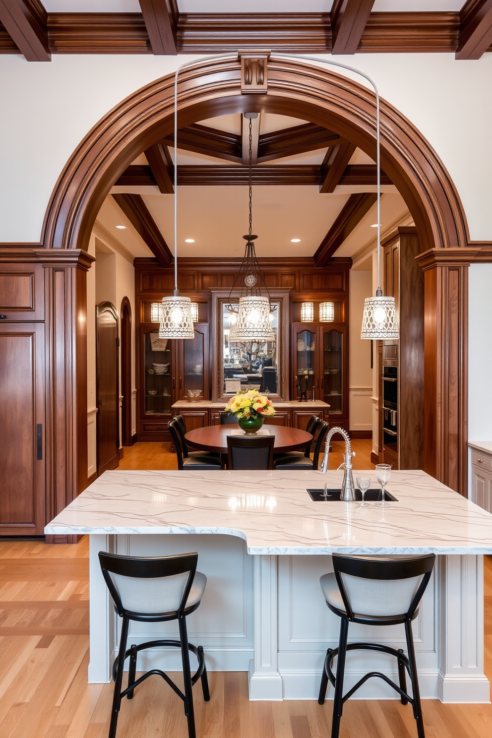 A warm and inviting kitchen with an arched doorway leading into the dining area. The arch is adorned with intricate woodwork, seamlessly blending traditional and modern design elements. The kitchen features a large island with a marble countertop and stylish bar stools. Soft pendant lights hang above the island, creating a cozy atmosphere for gatherings.