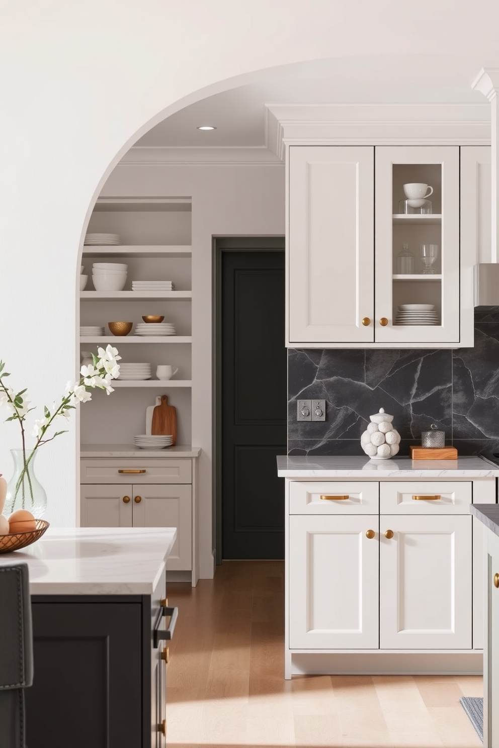 A stylish arch frames the kitchen entrance, seamlessly integrating elegant cabinetry that enhances the overall aesthetic. The cabinetry features a mix of open shelves and closed storage, all finished in a soft matte white with brass hardware accents.