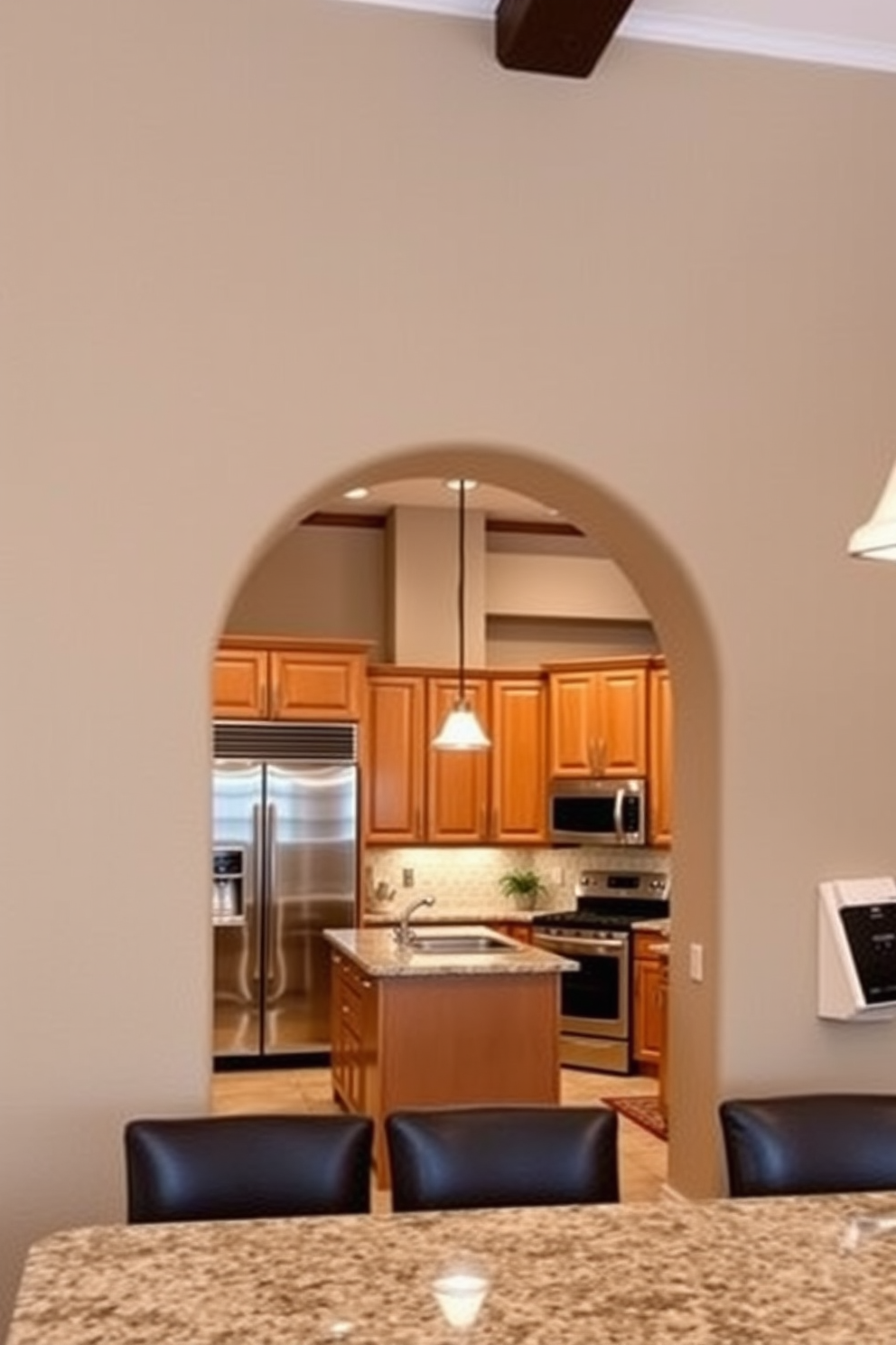 A beautifully designed kitchen featuring a textured arch with a stucco finish. The arch frames a spacious entrance to the cooking area, complemented by warm wooden cabinetry and sleek stainless steel appliances.