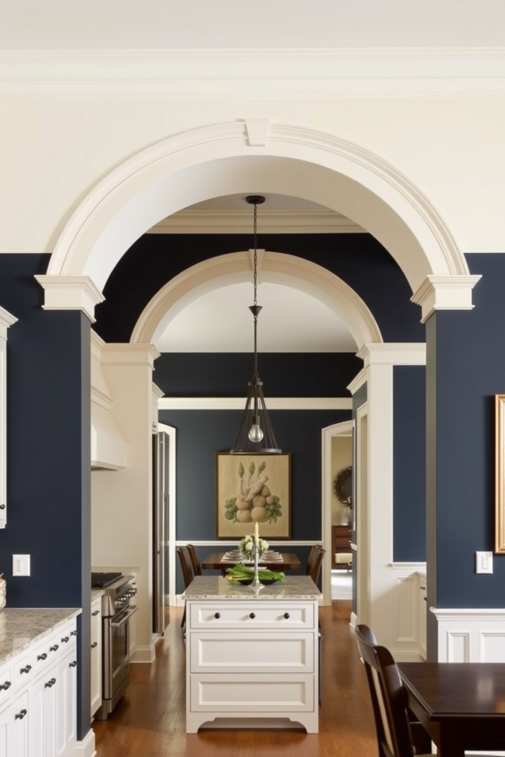 A spacious kitchen features an arched opening that seamlessly connects the cooking area to the dining space. The walls are painted in contrasting colors, with one side a soft cream and the other a deep navy blue, creating a striking visual effect. The arch is adorned with decorative molding that adds elegance to the design. Underneath the arch, a stylish pendant light hangs, illuminating the transition between the two areas.