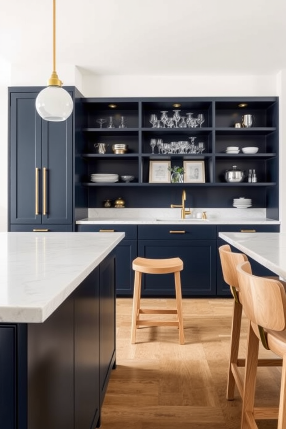 A stylish kitchen bar area featuring sleek cabinetry in a deep navy blue paired with brass hardware. The countertop is a polished white quartz with subtle veining, and bar stools in a light wood finish provide comfortable seating. The back wall showcases open shelving displaying a curated selection of glassware and decorative items. Soft pendant lighting hangs above the bar, creating a warm and inviting atmosphere for entertaining guests.