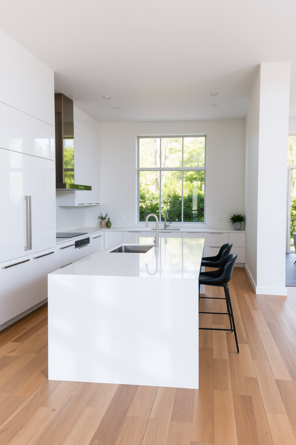 A minimalist kitchen design featuring sleek lines and an open layout. The cabinetry is a high-gloss white with integrated handles, and the countertops are a smooth quartz in a light gray tone. A large island sits at the center, topped with a waterfall edge and accompanied by minimalist bar stools. Natural light floods the space through large windows, highlighting the subtle textures of the wood flooring.