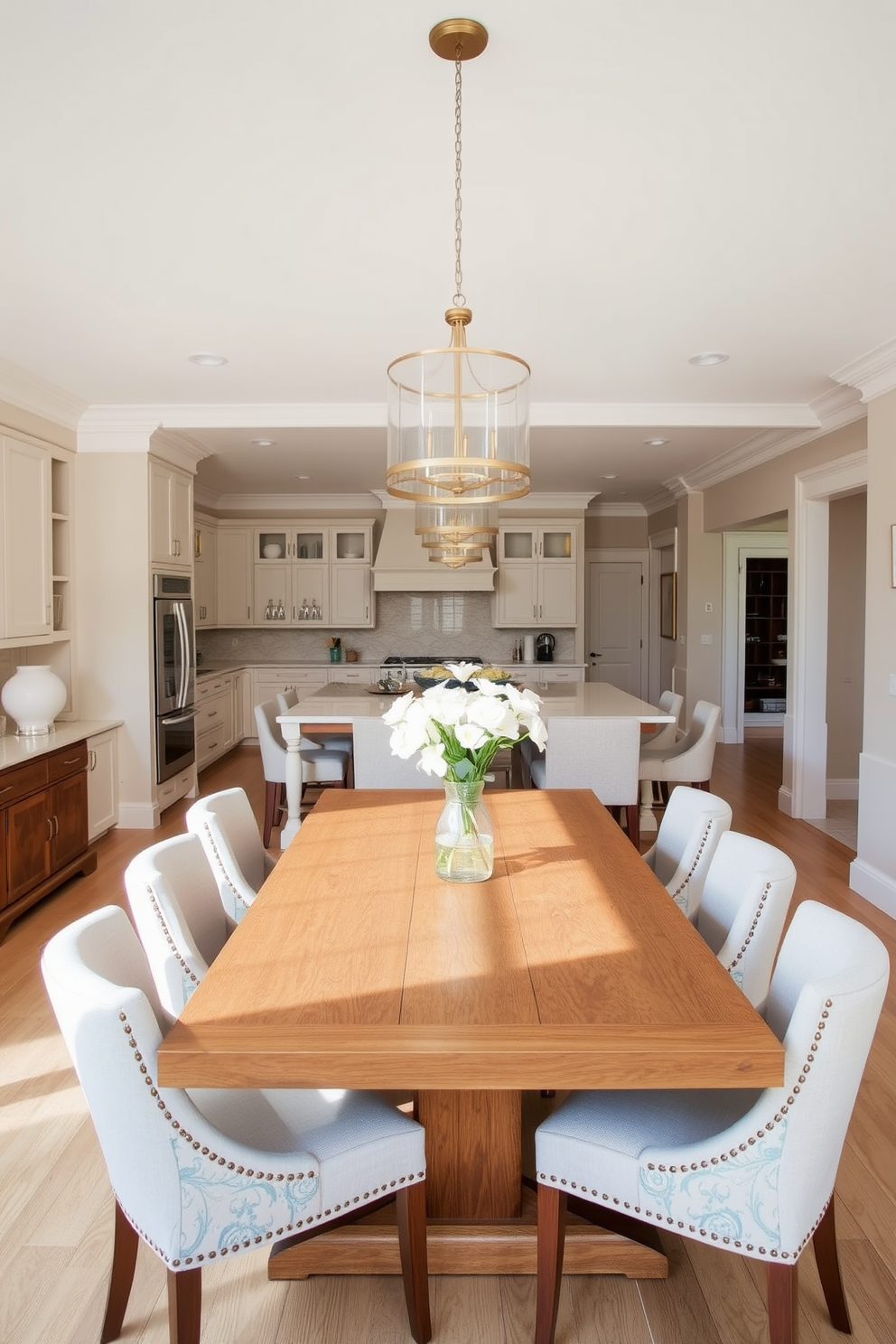 A bright and airy kitchen dining room combo featuring natural elements. There are large windows that let in plenty of sunlight, surrounded by lush green plants and herbs on the windowsill. The dining area includes a rustic wooden table paired with comfortable upholstered chairs. Above the table, a statement chandelier made of natural materials adds warmth and elegance to the space.