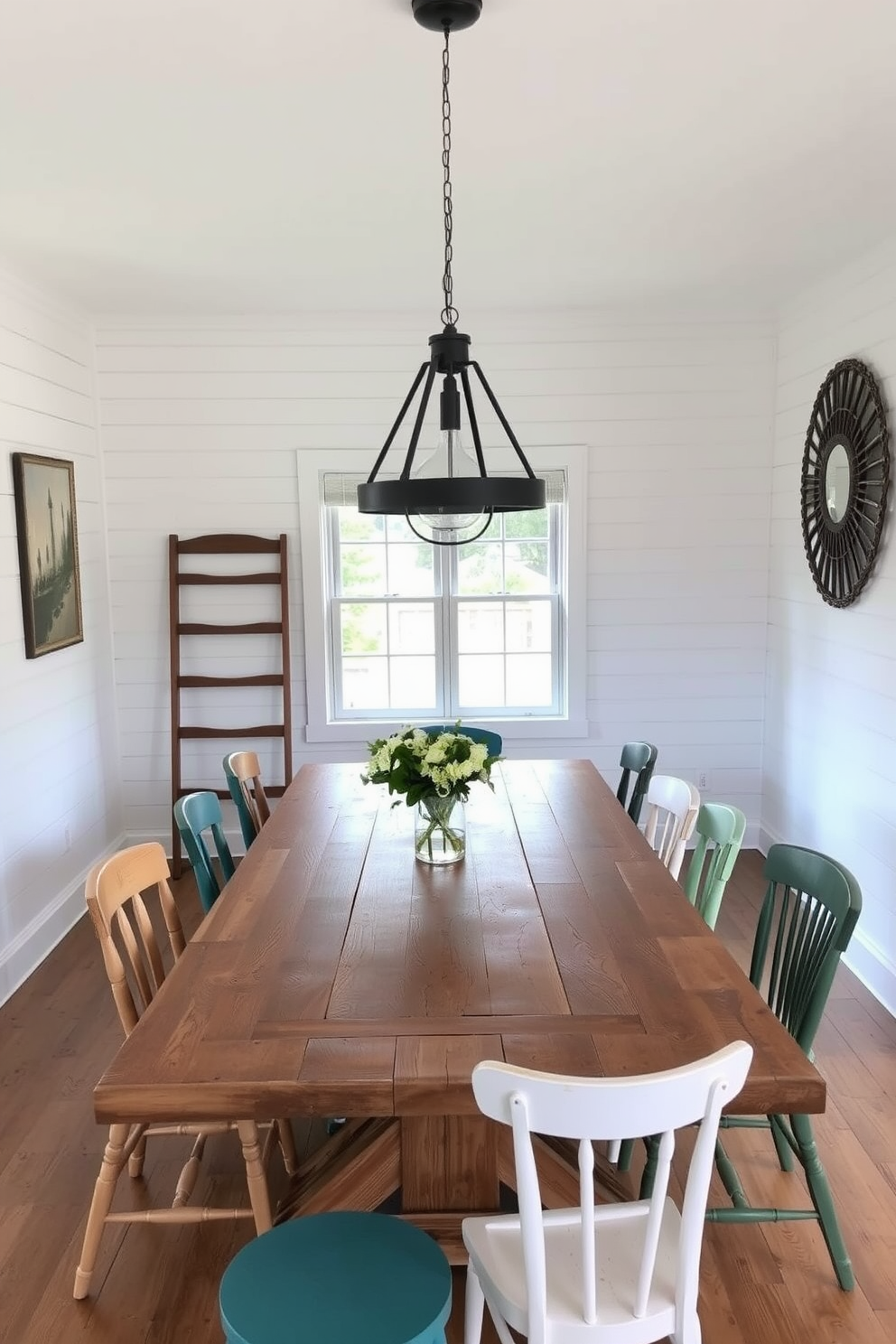 A rustic farmhouse table made of reclaimed wood is the centerpiece of the dining room. Surrounding it are mismatched chairs in various styles and colors, adding a charming eclectic touch to the space. The walls are adorned with shiplap in a soft white finish, creating a bright and airy atmosphere. A large, vintage-style pendant light hangs above the table, illuminating the inviting dining area.