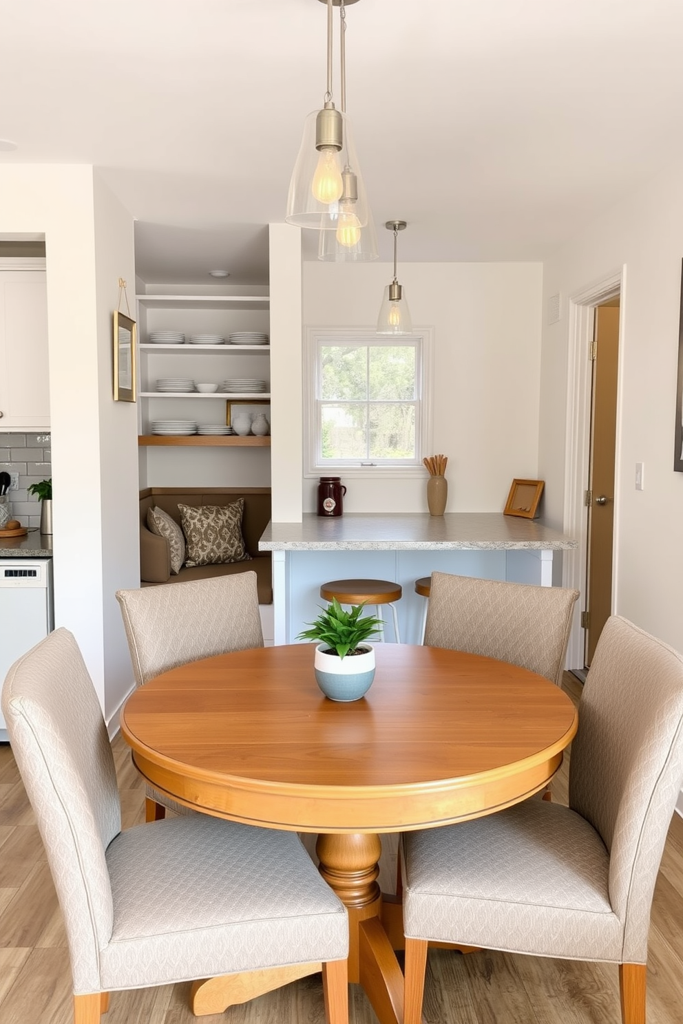 A compact kitchen dining area featuring a round wooden table surrounded by four upholstered chairs. The walls are painted in a light pastel color, and a small potted plant sits on the table to add a touch of greenery. The kitchen includes open shelving displaying stylish dishware and a cozy nook with a built-in bench. Soft lighting fixtures hang above the table, creating an inviting atmosphere for meals and gatherings.