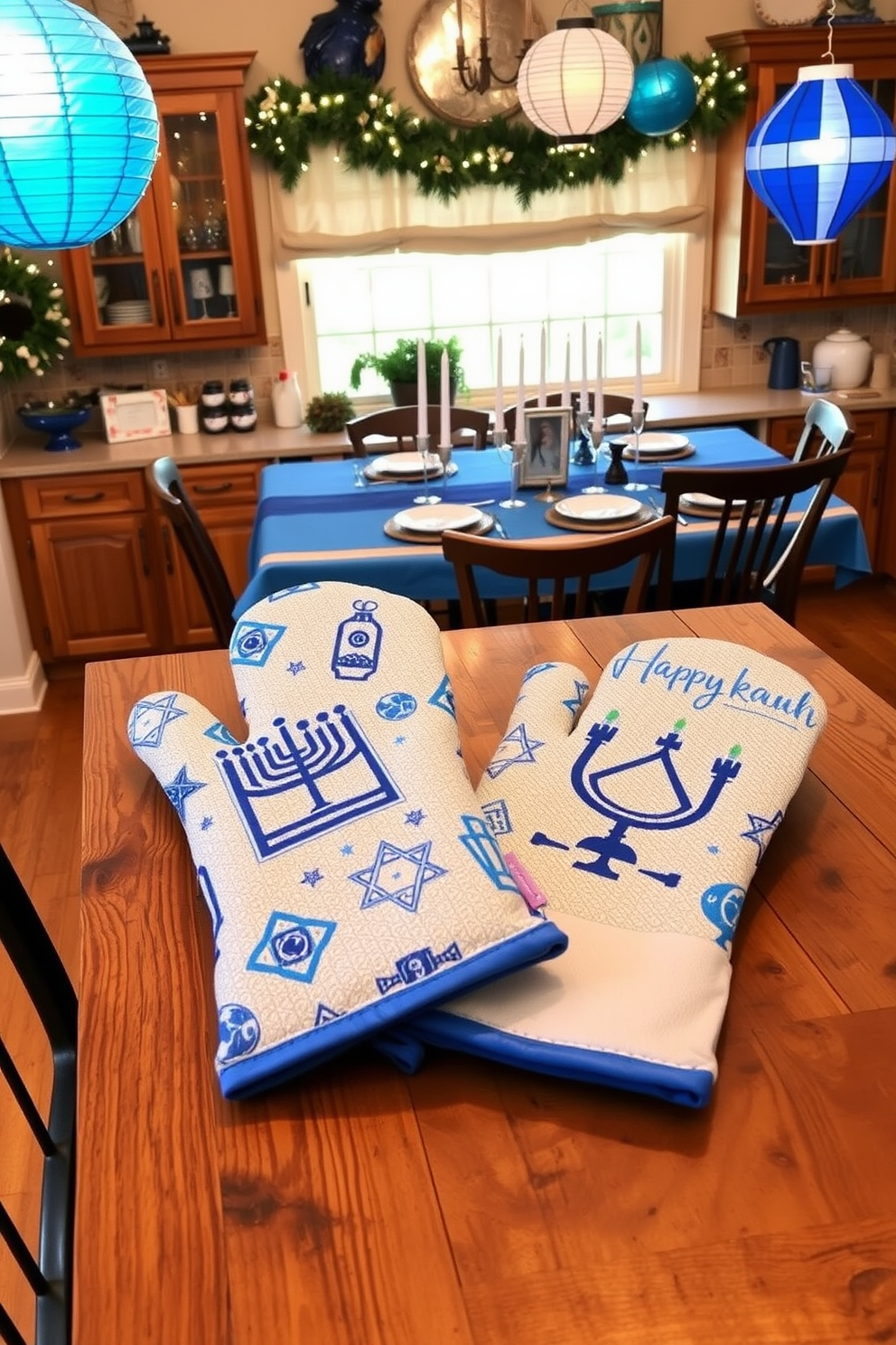 Stylish Hanukkah-themed oven mitts are displayed on a rustic wooden kitchen table. The mitts feature vibrant blue and silver patterns, showcasing traditional symbols like menorahs and dreidels. The kitchen is adorned with festive Hanukkah decorations, including a beautifully set table with a blue tablecloth and silver accents. Hanging from the cabinets are string lights and paper lanterns, creating a warm and inviting atmosphere for holiday gatherings.