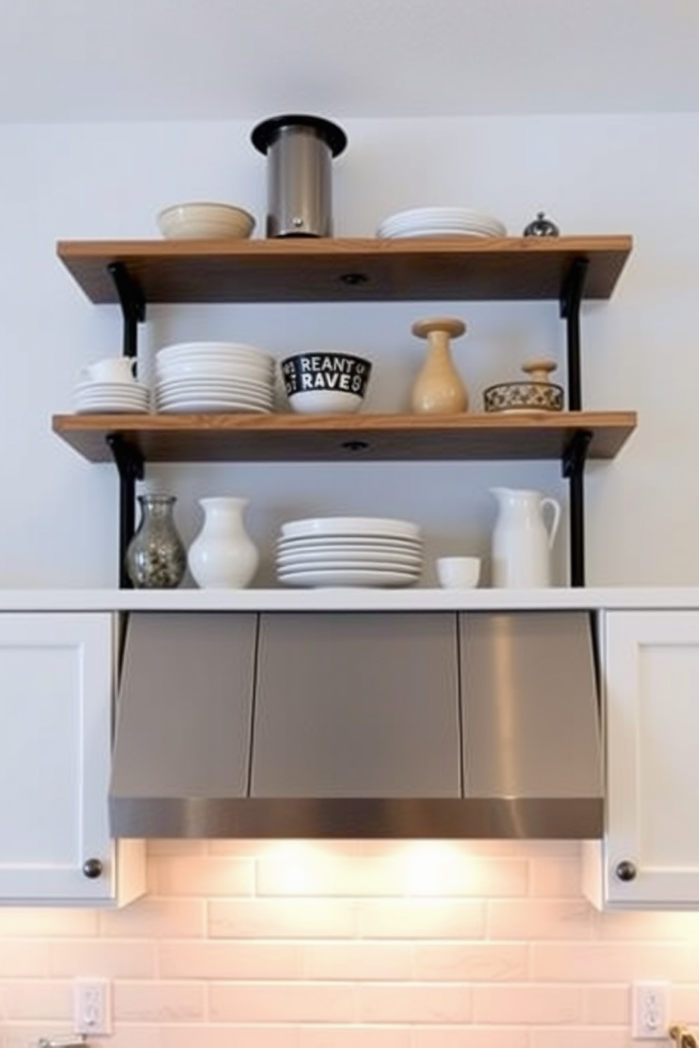 Open shelving above a stylish kitchen hood creates a modern and functional focal point in the kitchen. The shelves are filled with carefully curated dishware and decorative items, enhancing the overall aesthetic of the space. The kitchen hood features sleek lines and a contemporary finish that complements the cabinetry below. Underneath, a warm light illuminates the shelving, highlighting the curated collection and adding an inviting ambiance.