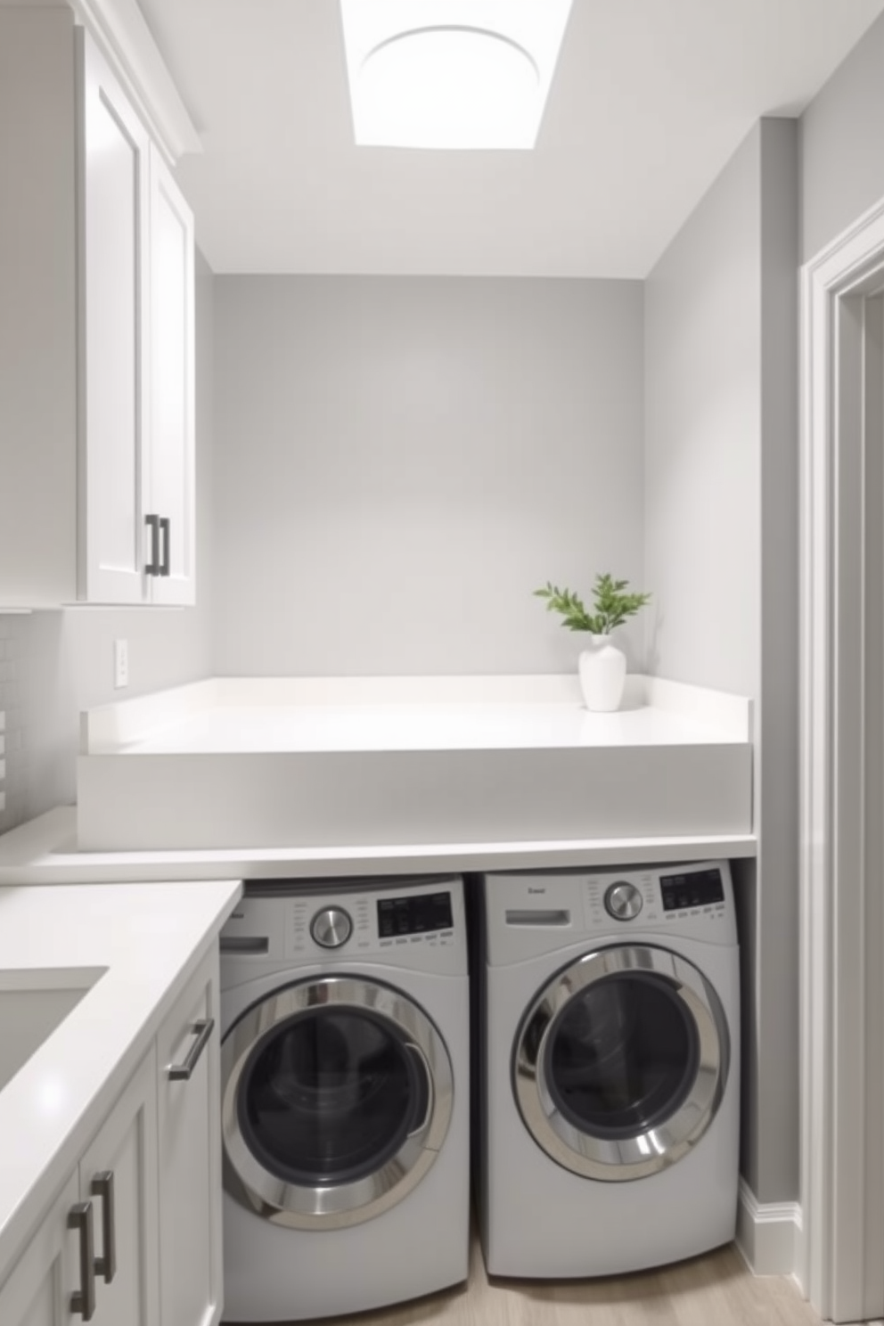 A compact washer dryer is seamlessly integrated under a sleek kitchen counter, maximizing space while maintaining a modern aesthetic. The surrounding cabinetry features a clean white finish, complemented by brushed nickel hardware for a polished look. Above the washer dryer, open shelving displays neatly arranged laundry essentials and decorative items, adding a personal touch to the functional space. The walls are painted in a soft gray hue, while the floor is adorned with stylish, water-resistant tiles for durability and easy maintenance.