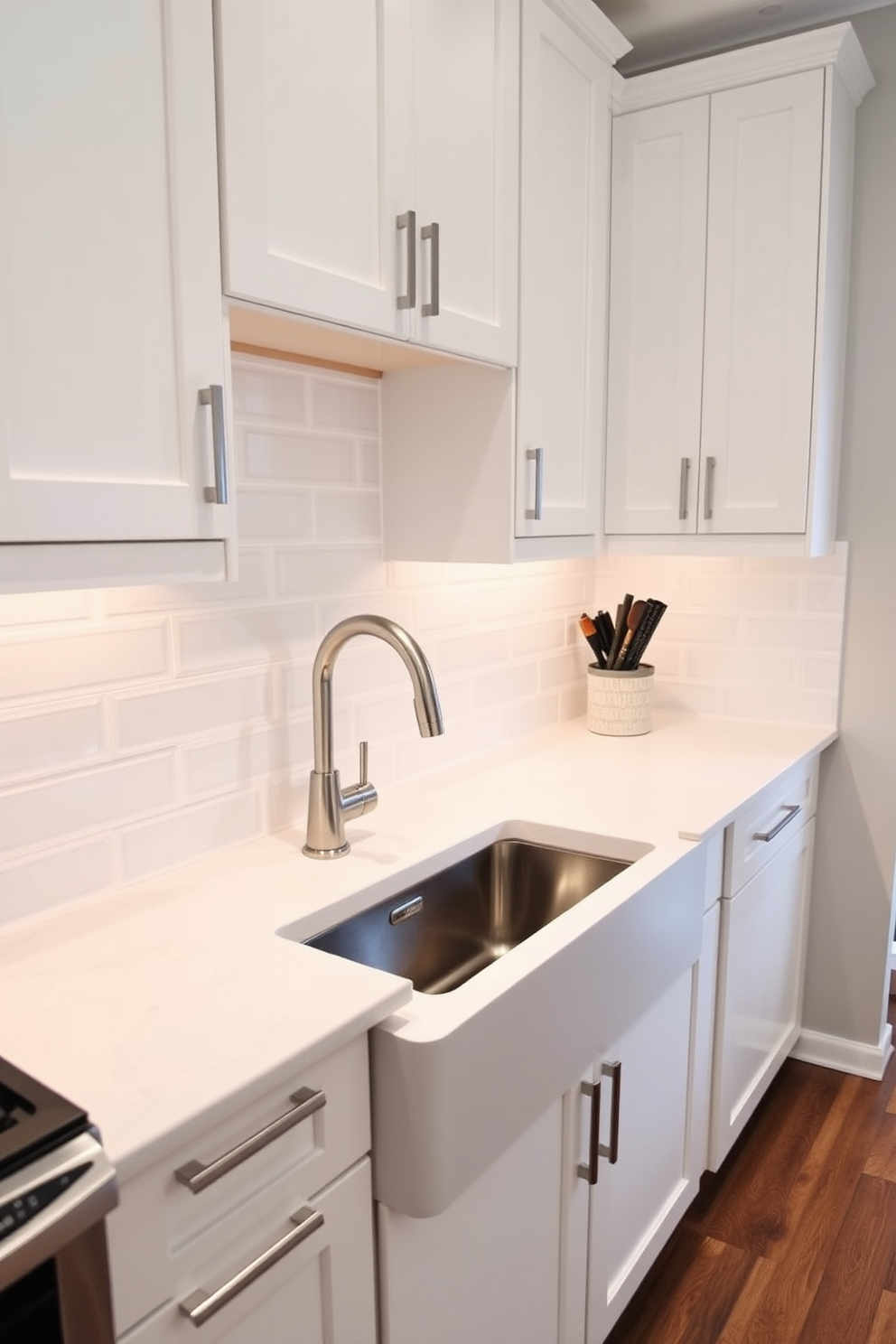 A modern kitchen featuring a recessed sink seamlessly integrated into the countertop. The sleek design enhances the minimalist aesthetic while providing ample workspace around the sink area. The cabinetry is finished in a soft white with brushed nickel hardware, complementing the stainless steel appliances. A stylish backsplash of subway tiles adds texture and visual interest to the overall design.