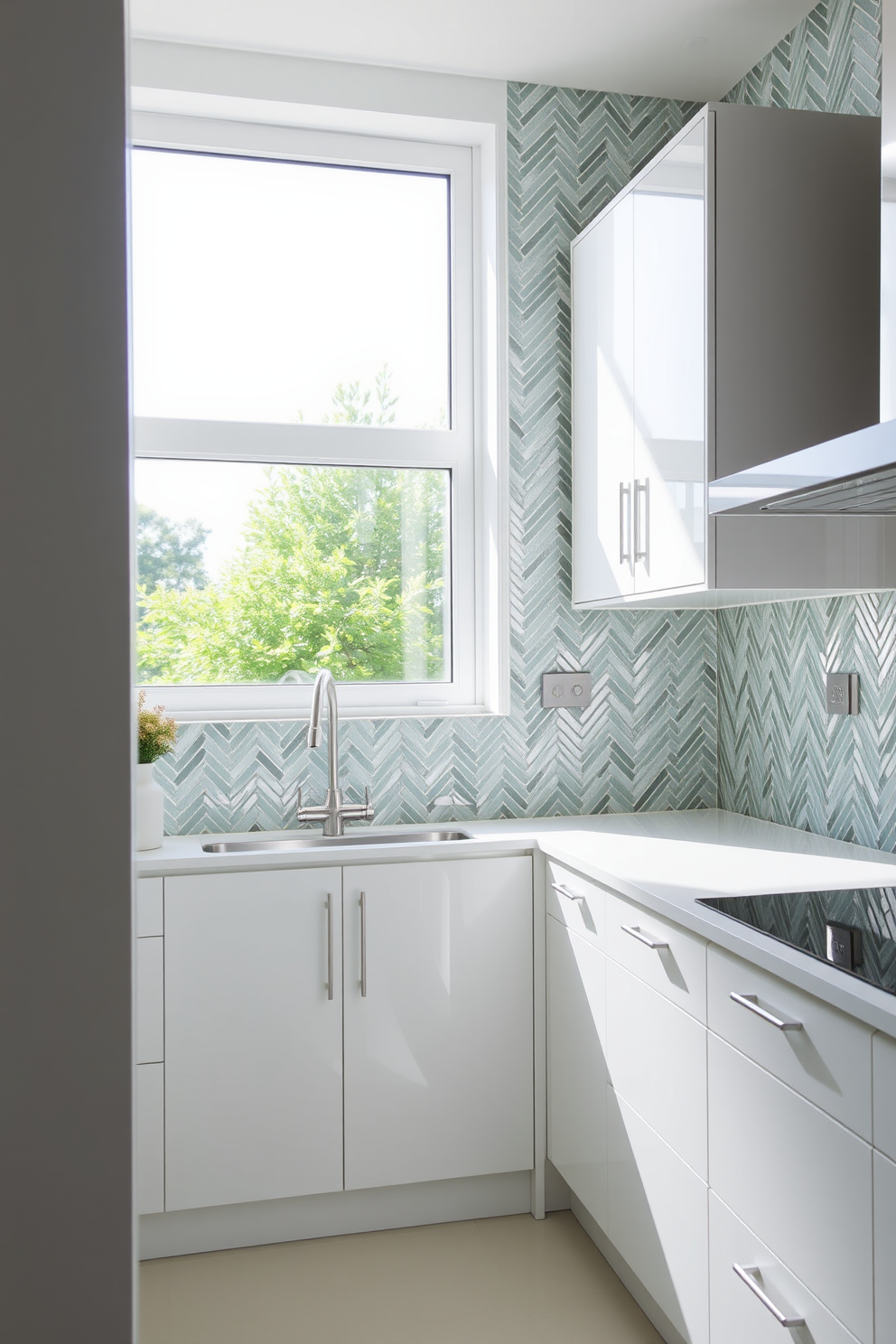 A modern kitchen featuring glass tiles that reflect light and create a sense of depth. The tiles are arranged in a herringbone pattern, adding texture and visual interest to the walls. The cabinetry is sleek and minimalist, painted in a soft white to enhance the brightness of the space. A large window allows natural light to flood in, further highlighting the shimmering glass tiles.