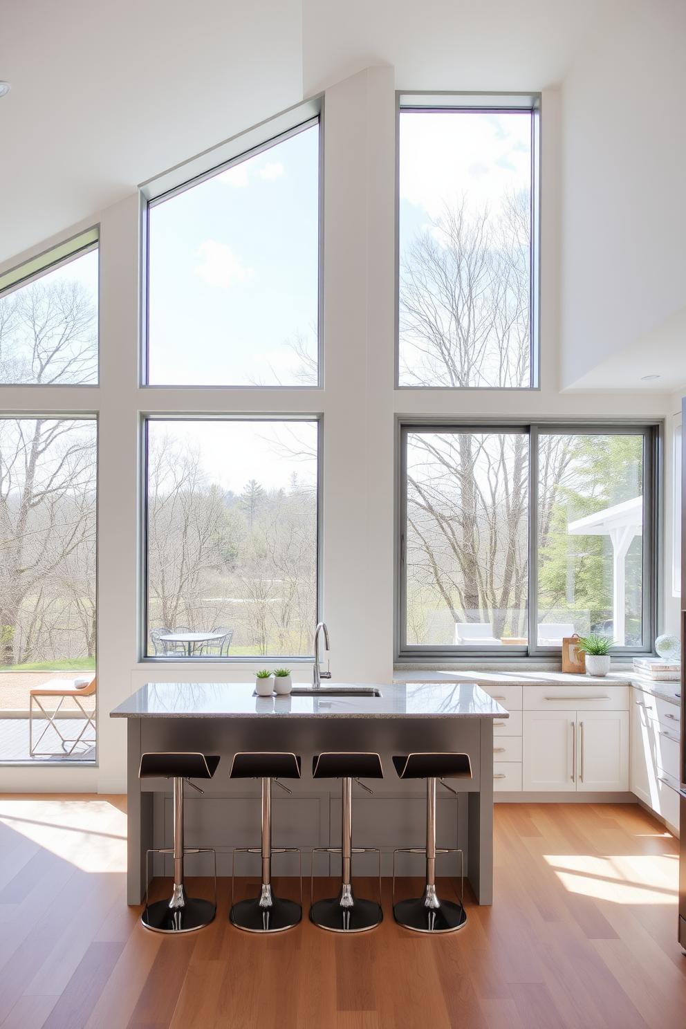 A bright and airy kitchen featuring floor to ceiling windows that flood the space with natural light. The windows are framed with sleek stainless steel, offering a modern touch while providing stunning views of the outdoor landscape. The kitchen island is positioned beneath the windows, adorned with elegant bar stools for casual dining. Soft white cabinetry complements the light wood flooring, creating a warm and inviting atmosphere.