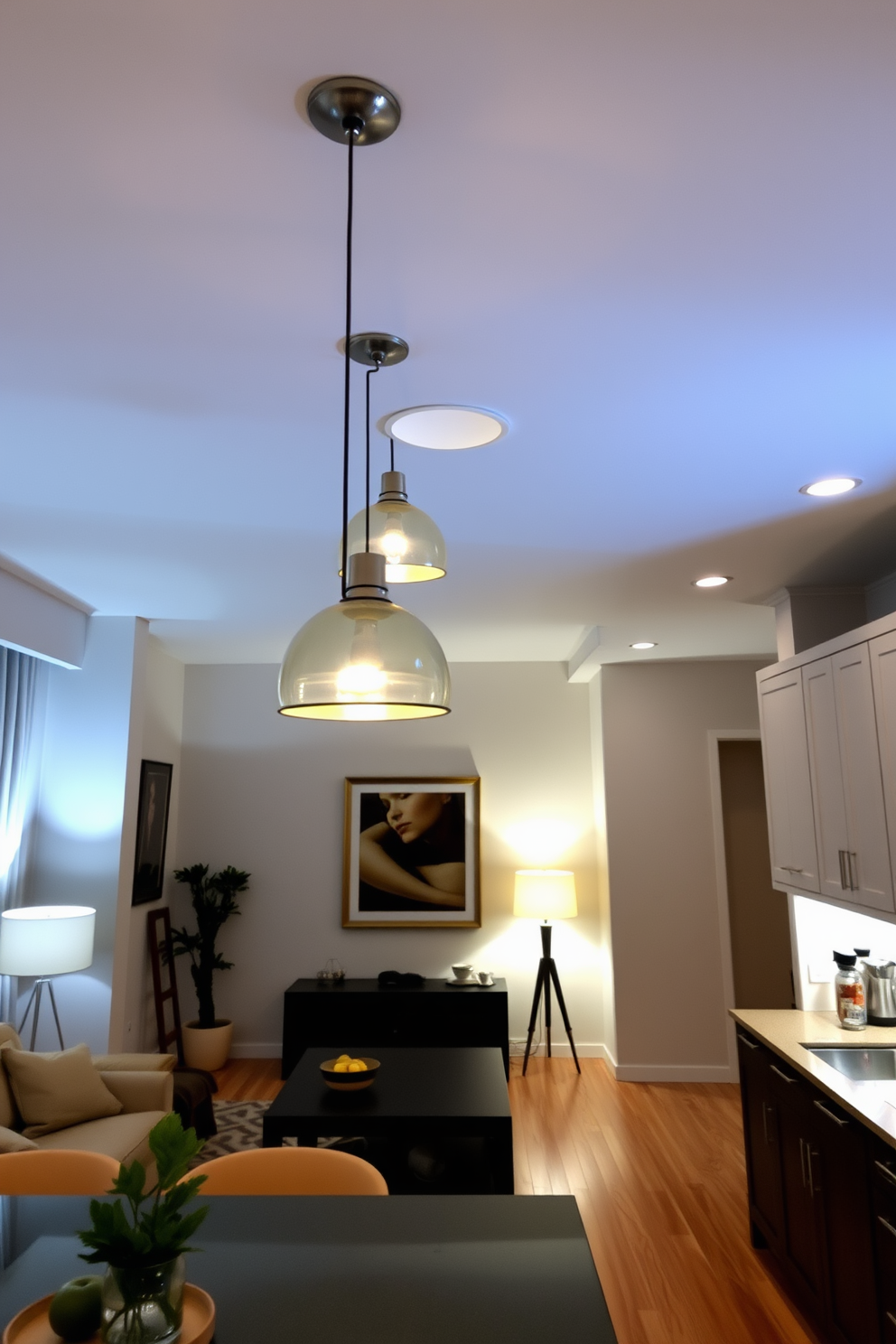 Layered lighting creates a warm and inviting atmosphere in an L-shaped apartment. Soft pendant lights hang from the ceiling, while floor lamps provide additional illumination in cozy corners. The living area features a combination of recessed lighting and strategically placed sconces to highlight artwork on the walls. In the kitchen, under-cabinet lighting enhances the countertops, making the space functional and stylish.