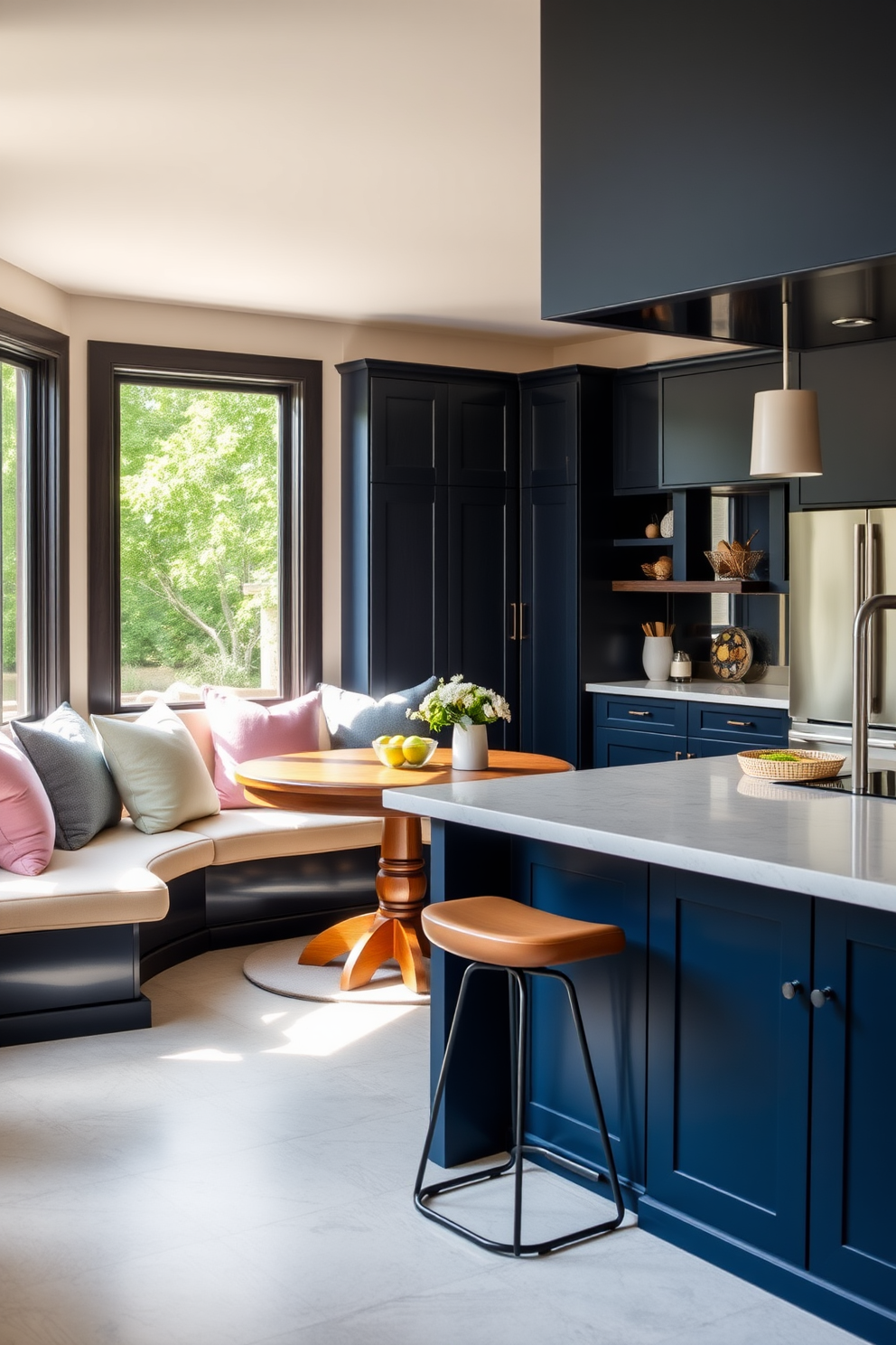 Cozy breakfast nook with built-in seating. The nook features a round wooden table surrounded by plush cushions in soft pastel colors, with large windows allowing natural light to flood the space. L-shaped kitchen design ideas. The kitchen includes sleek cabinetry in a deep navy blue, a spacious island with bar stools, and stainless steel appliances that complement the modern aesthetic.