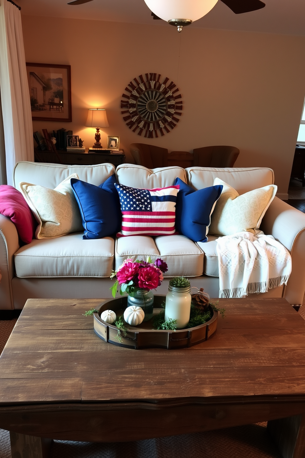 A cozy living room setting designed for Labor Day celebrations. A plush sofa is adorned with colorful throw pillows and a soft blanket draped over one armrest. A rustic coffee table sits in front, topped with seasonal decorations and a small vase of fresh flowers. Warm ambient lighting creates an inviting atmosphere, perfect for gathering with friends and family.