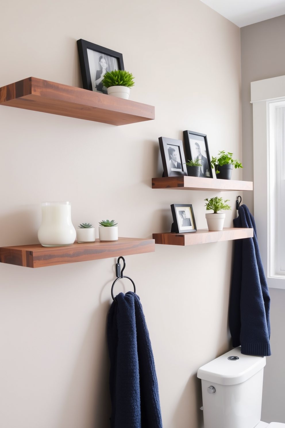 A stylish bathroom featuring floating shelves on the walls to showcase decorative items and plants. The shelves are made of reclaimed wood, adding warmth to the space, and are adorned with curated decor pieces such as candles, small potted plants, and framed photos. The color palette includes soft neutral tones with accents of navy blue for a fresh look. A plush navy towel hangs elegantly on a hook, complementing the overall design while providing a cozy touch.