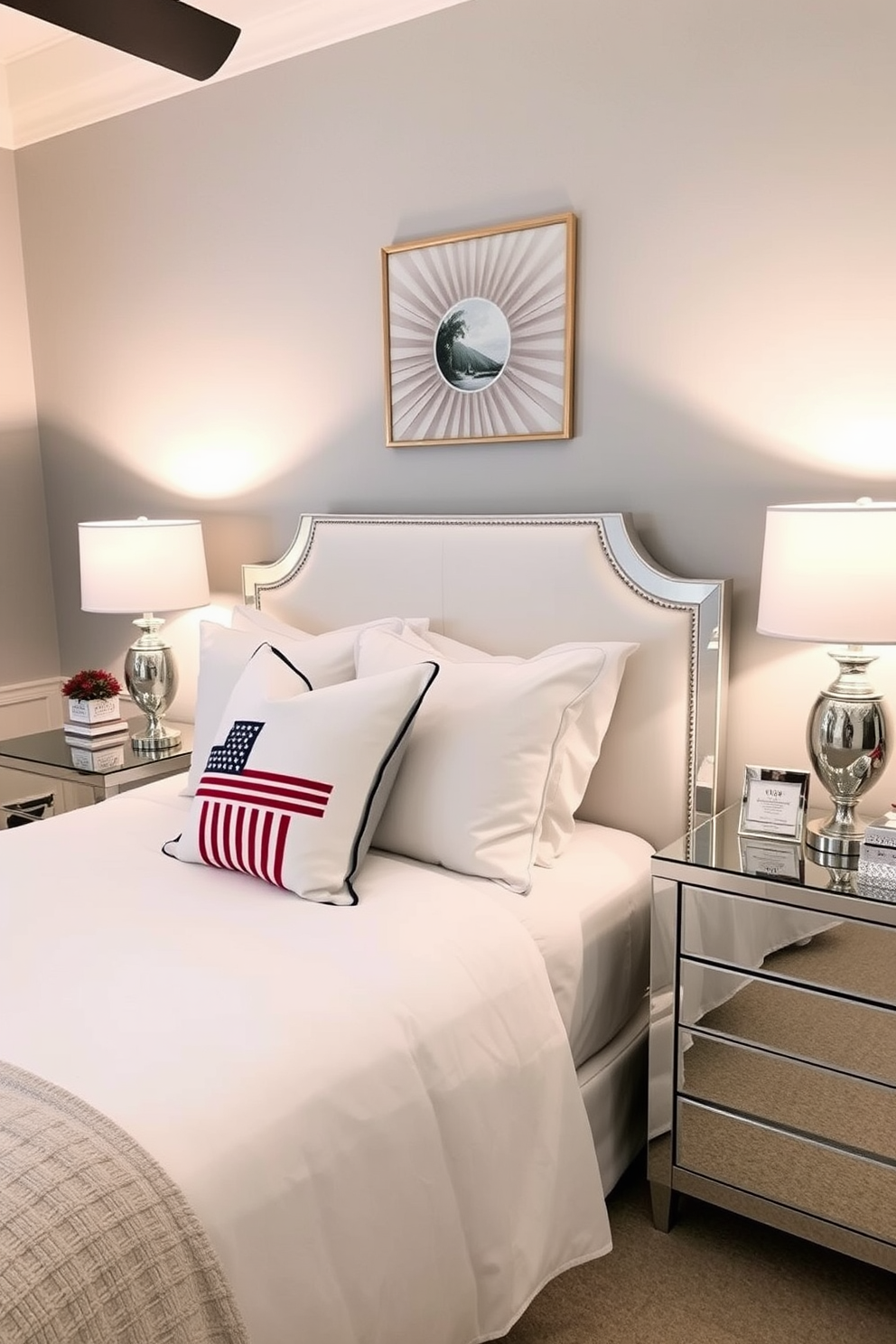 A stylish bedroom featuring mirrored furniture that adds a modern touch. The bed is dressed in crisp white linens, and a sleek mirrored nightstand sits on either side, reflecting the soft ambient lighting. The walls are painted in a calming gray tone, creating a serene atmosphere. Decorative Labor Day-themed accents, such as subtle red, white, and blue throw pillows, enhance the seasonal decor while maintaining an elegant aesthetic.