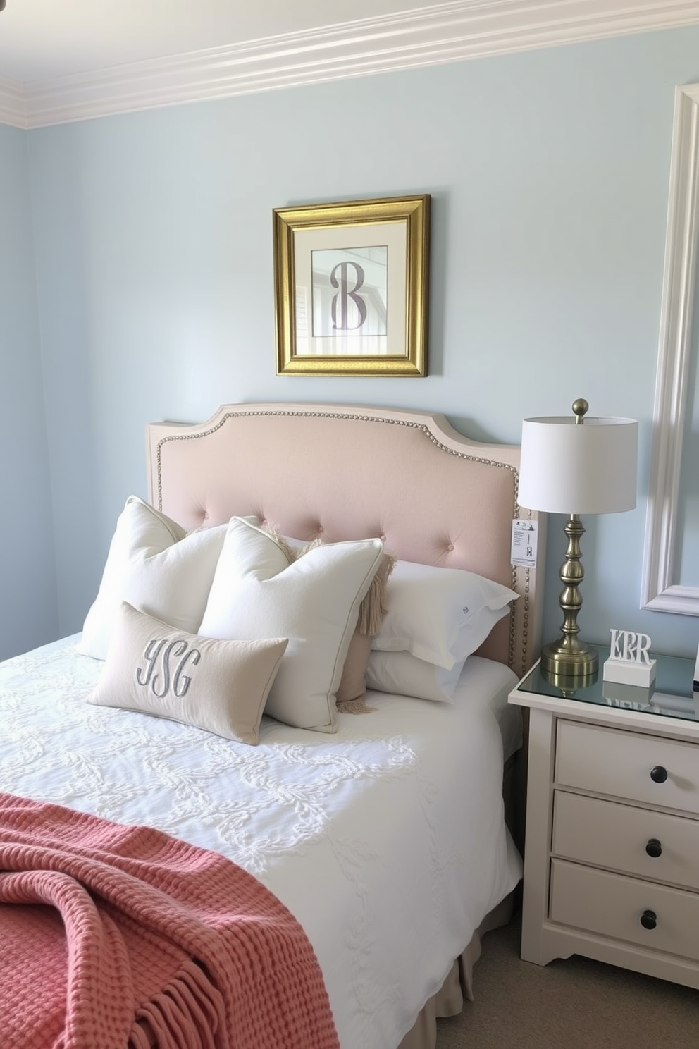 A cozy bedroom retreat featuring a plush king-sized bed adorned with a mix of patterned throw pillows and a textured knit blanket. The walls are painted in a soft taupe, complemented by a geometric patterned area rug that adds warmth to the hardwood floor. A stylish nightstand on either side of the bed showcases unique lamps with fabric shades, creating a harmonious balance of light and texture. A gallery wall above the bed displays a collection of framed art pieces, incorporating various styles and colors to enhance the room's personality.