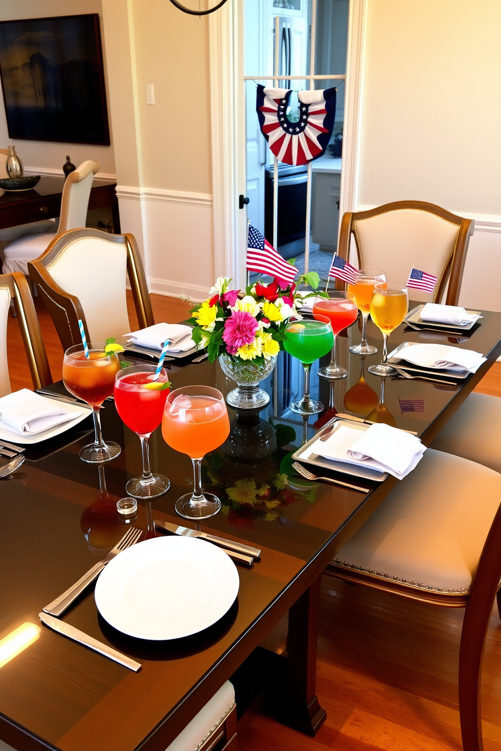 A beautifully set dining table adorned with elegant glassware filled with vibrant summer cocktails. The table is surrounded by stylish chairs, and a centerpiece of fresh flowers adds a touch of color to the scene. The dining room features soft lighting that enhances the warm ambiance, with light-colored walls and a polished wooden floor creating a welcoming atmosphere. Seasonal decorations subtly incorporate Labor Day themes, such as small flags and red, white, and blue accents, bringing a festive spirit to the gathering.