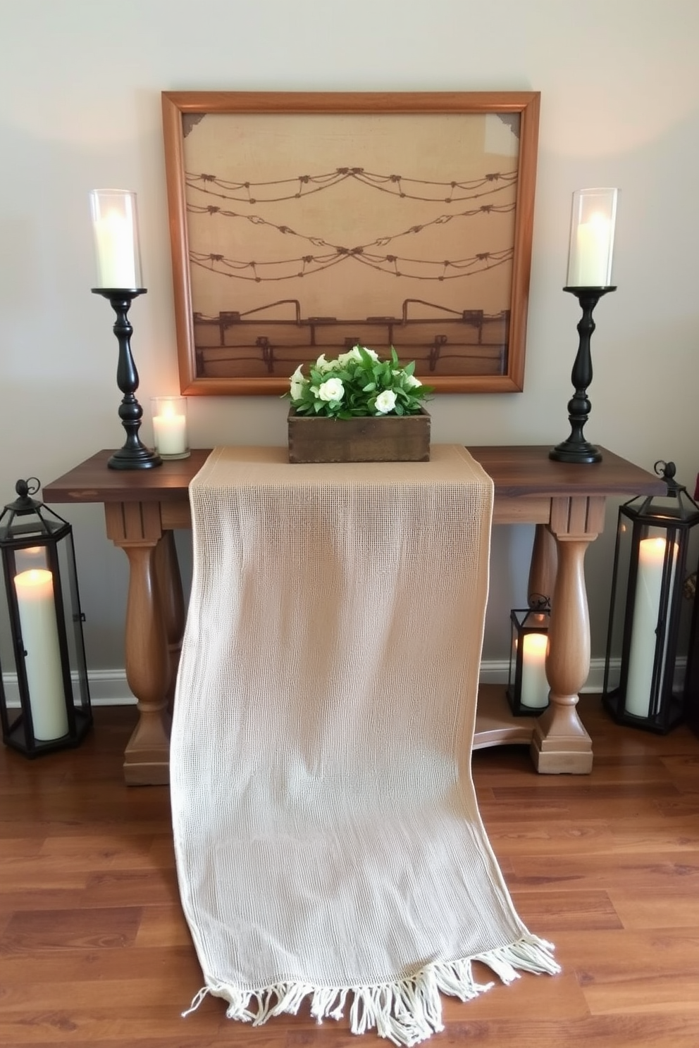 A burlap runner elegantly drapes across a rustic console table, enhancing the warm ambiance of the entryway. Flanking the table are decorative lanterns filled with soft glowing candles, inviting guests into a cozy and welcoming space.