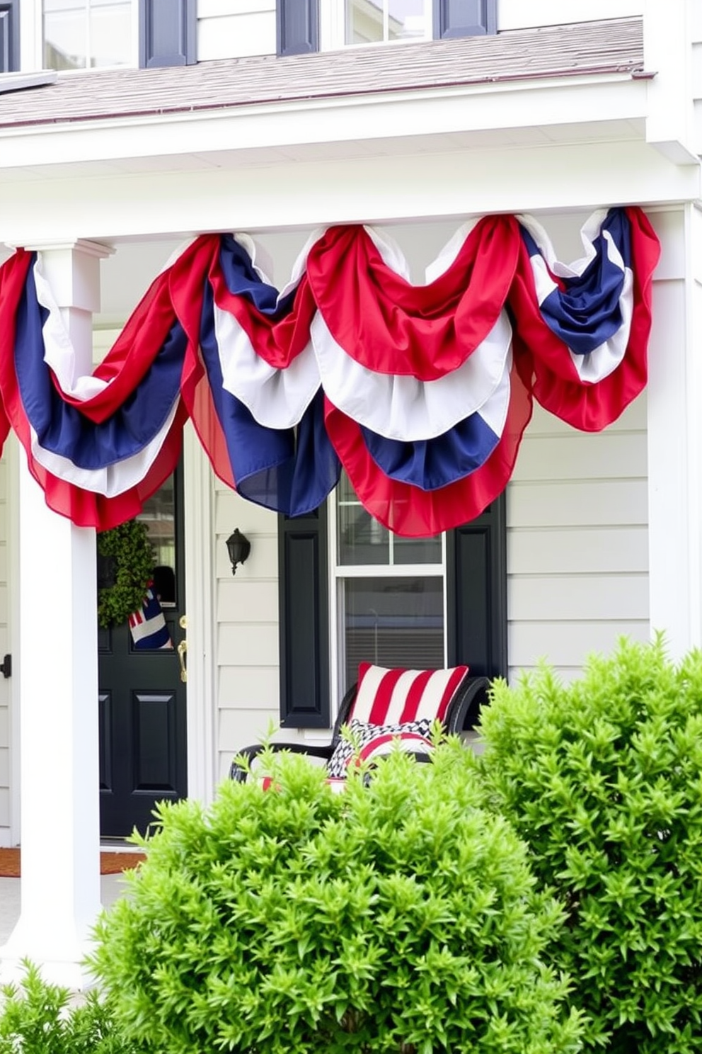 Layered fabric banners in red white and blue hang gracefully from the front porch. The banners create a festive atmosphere welcoming guests to celebrate Labor Day.