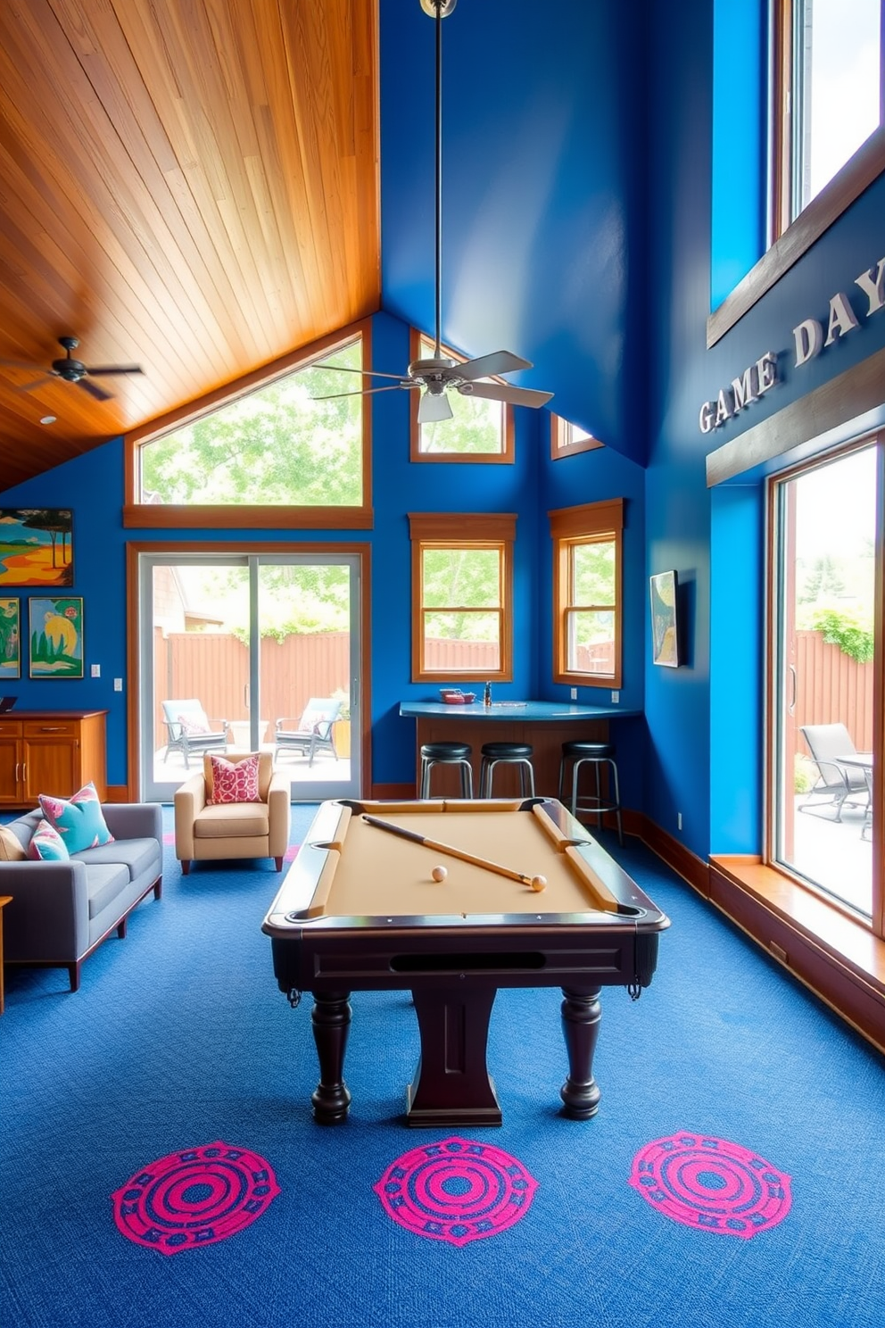 A vibrant game room with large windows that open to an outdoor patio. The space features a pool table at the center, surrounded by comfortable seating and colorful wall art. The walls are painted in a lively blue hue, complemented by wooden accents throughout. A bar area with high stools is positioned in one corner, perfect for entertaining guests during Labor Day celebrations.