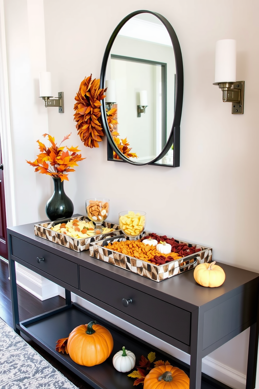 A stylish hallway adorned with decorative trays featuring an array of seasonal snacks. The trays are placed on a sleek console table, complemented by autumn-themed decor such as small pumpkins and vibrant leaves.